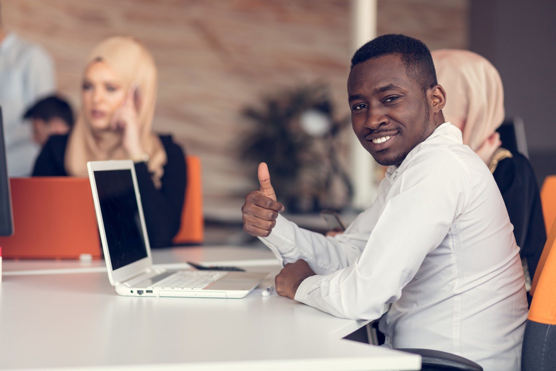 Multiracial contemporary business people working connected with technological devices