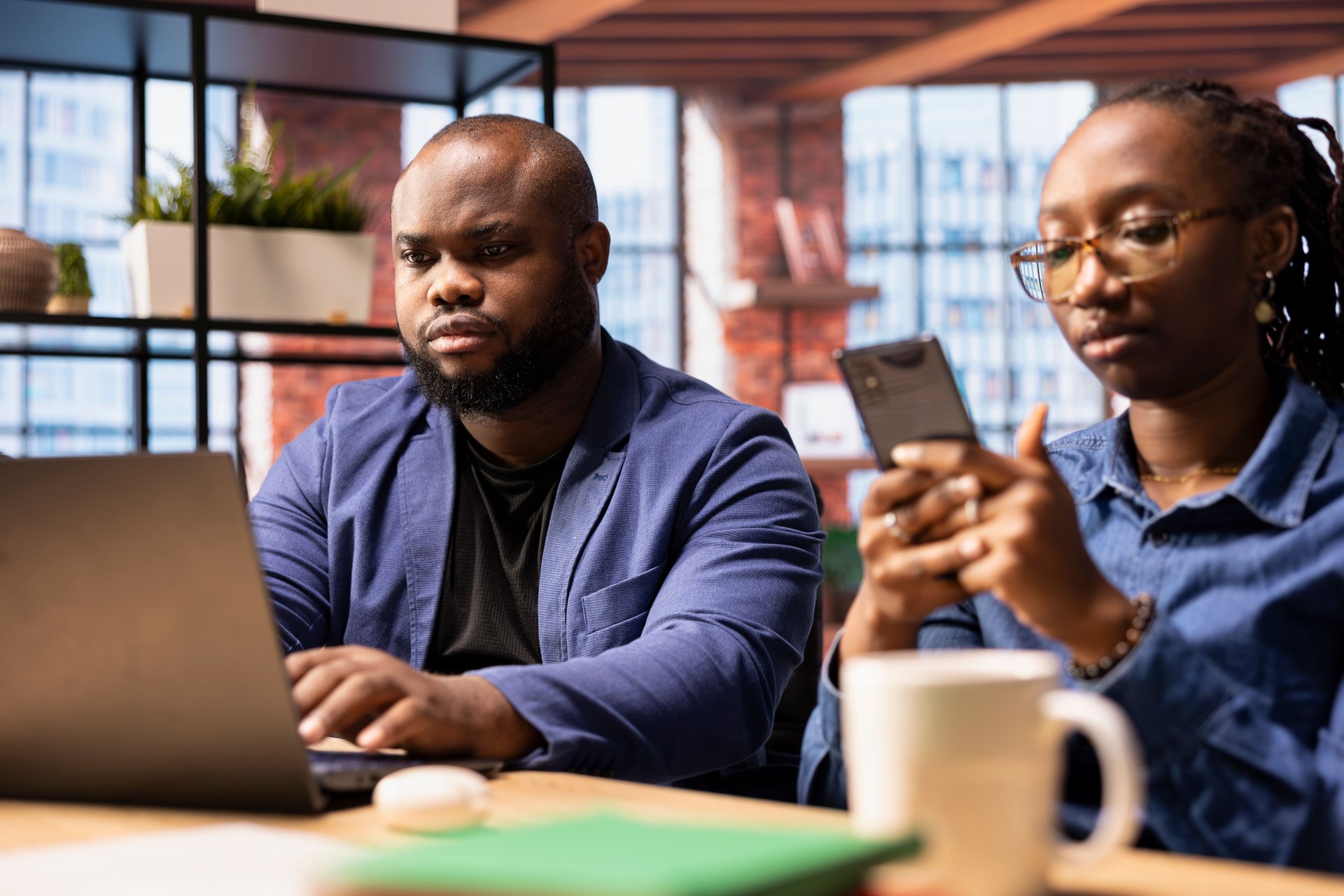 African American couple in a modern flat collaborate on a consulting project